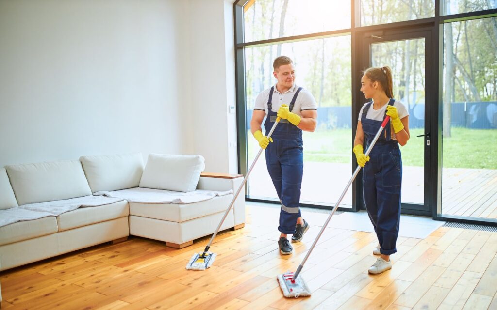 2 maids cleaning the living room for one-time cleaning services. Avail our limited time cleaning promotions now.