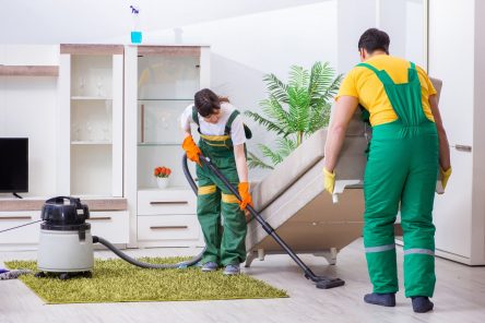 2 maids doing house cleaning service in living room for occasional cleaning service